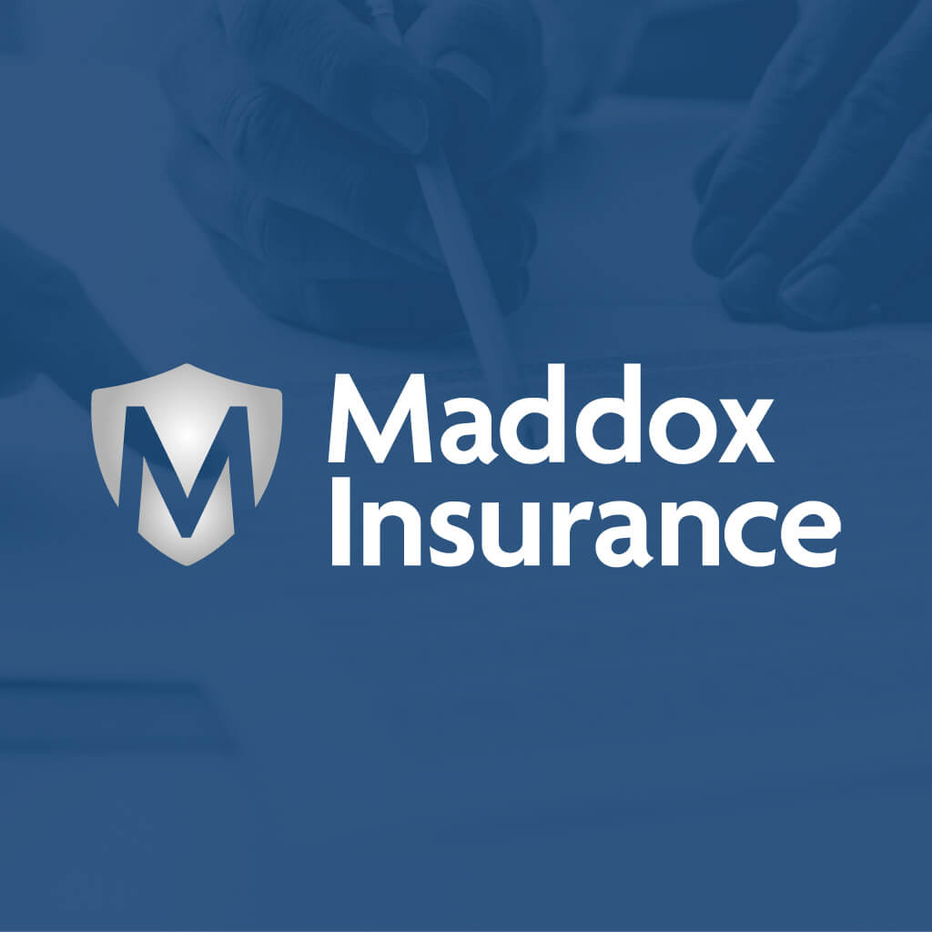 Maddox Insurance logo featuring a stylized 'M' shield next to the white text on a blue background with faint hands signing a document.